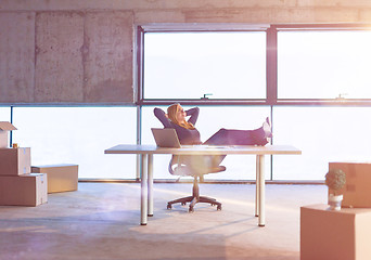 Image showing young female architect taking a break on construction site