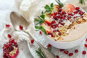 Image showing Healthy smoothie bowl of strawberries, pomegranate and almonds.