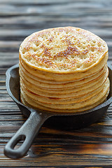 Image showing Stack of pancakes in a cast iron pan.