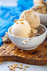 Image showing Ice cream with seeds and halva in a white bowl.