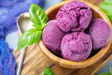 Image showing Blueberry ice cream with green basil close-up.