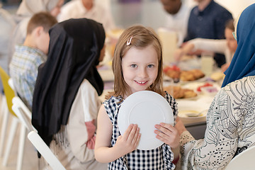 Image showing cute little girl enjoying iftar dinner with family