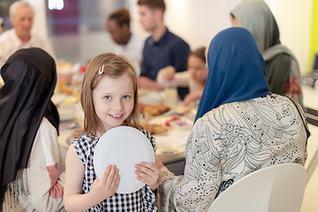 Image showing cute little girl enjoying iftar dinner with family