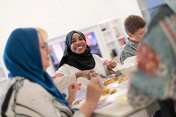 Image showing black modern muslim woman enjoying iftar dinner with family