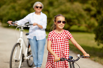 Image showing grandmother and granddaughter with bicycles