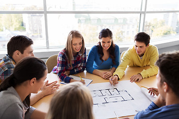 Image showing group of smiling students with blueprint