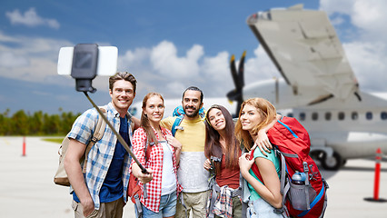 Image showing friends taking selfie by smartphone on airfield