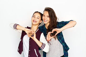 Image showing happy smiling teenage girls showing heart sing