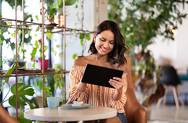 Image showing happy woman with tablet pc at cafe or coffee shop