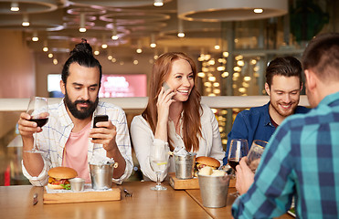 Image showing friends dining and drinking wine at restaurant