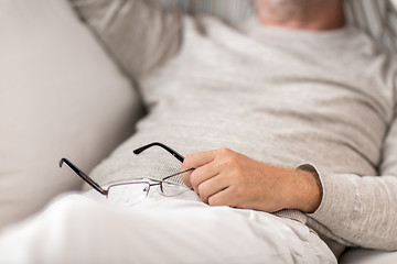 Image showing close up of senior man with glasses sleeping