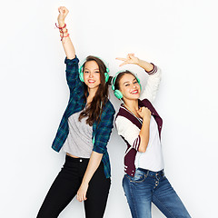 Image showing teenage girls in earphones listening to music