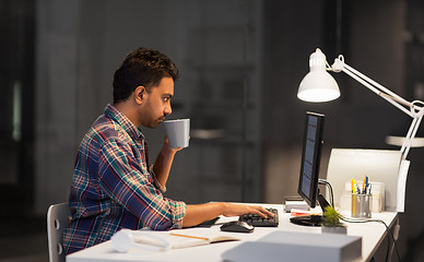 Image showing creative man with computer working late at office