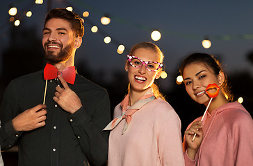 Image showing happy friends with party props at rooftop