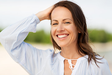 Image showing happy smiling woman on summer beach