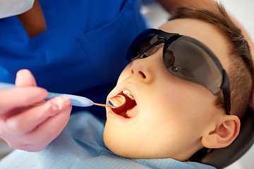 Image showing boy having teeth checkup at dental clinic