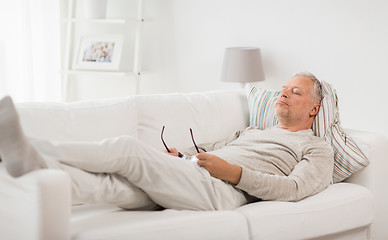 Image showing senior man sleeping on sofa at home