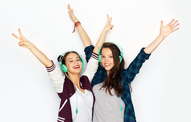 Image showing teenage girls in earphones listening to music