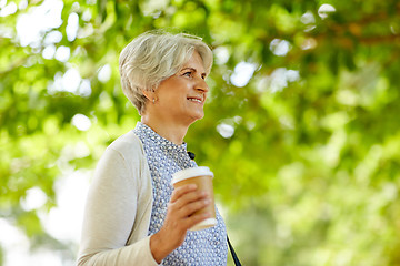 Image showing senior woman drinking takeaway coffee at park