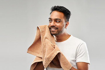 Image showing smiling indian man with towel over grey background