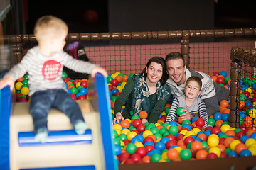 Image showing young parents with kids in a children\'s playroom