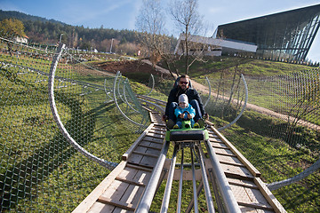 Image showing father and son enjoys driving on alpine coaster