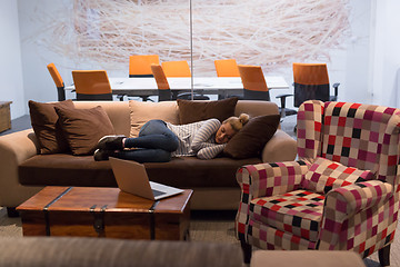 Image showing woman sleeping on a sofa  in a creative office