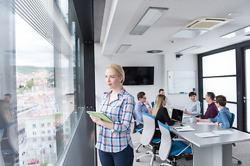 Image showing Pretty Businesswoman Using Tablet In Office Building by window