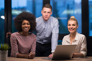 Image showing Multiethnic startup business team in night office