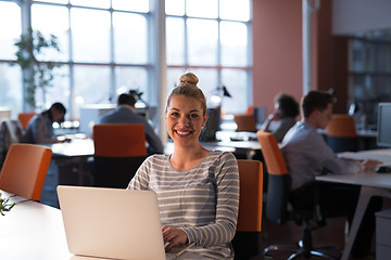 Image showing businesswoman using a laptop in startup office