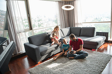 Image showing Happy family playing a video game