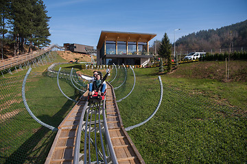 Image showing couple enjoys driving on alpine coaster