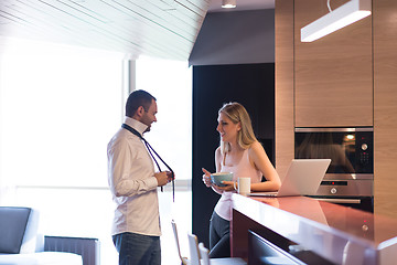 Image showing A young couple is preparing for a job and using a laptop