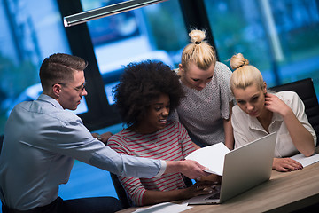 Image showing Multiethnic startup business team in night office