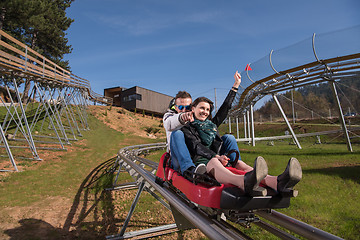 Image showing couple enjoys driving on alpine coaster