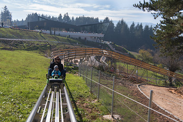 Image showing father and son enjoys driving on alpine coaster