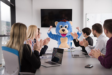 Image showing boss dresed as bear having fun with business people in trendy of