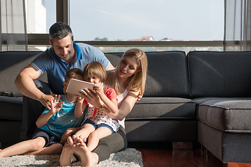 Image showing happy young couple spending time with kids