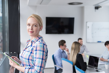 Image showing Pretty Businesswoman Using Tablet In Office Building by window