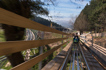 Image showing father and son enjoys driving on alpine coaster