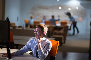 Image showing man using mobile phone in dark office