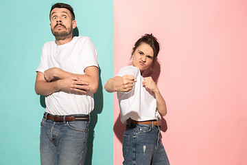 Image showing The young emotional angry woman on pink studio background