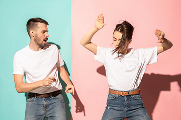 Image showing A couple of young man and woman dancing hip-hop at studio.