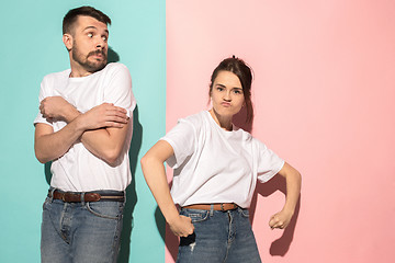 Image showing The young emotional angry woman on pink studio background