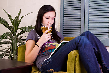 Image showing Cute Girl Drinking while Reading a Book