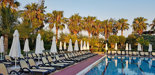 Image showing Summer resort: swimming pool and chaise loungues