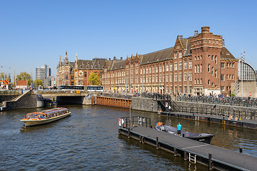 Image showing Sightseeng at Canal Boats near the Central Station of Amsterdam