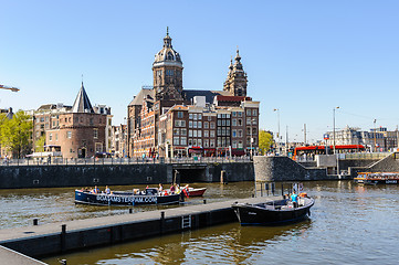 Image showing Sightseeng at Canal Boats near the Central Station of Amsterdam