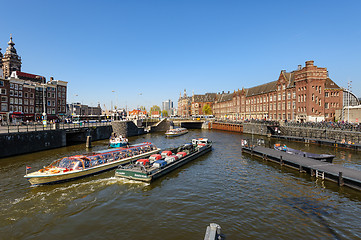 Image showing Sightseeng at Canal Boats near the Central Station of Amsterdam