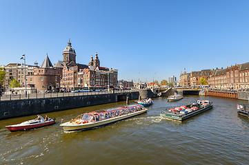 Image showing Sightseeng at Canal Boats near the Central Station of Amsterdam